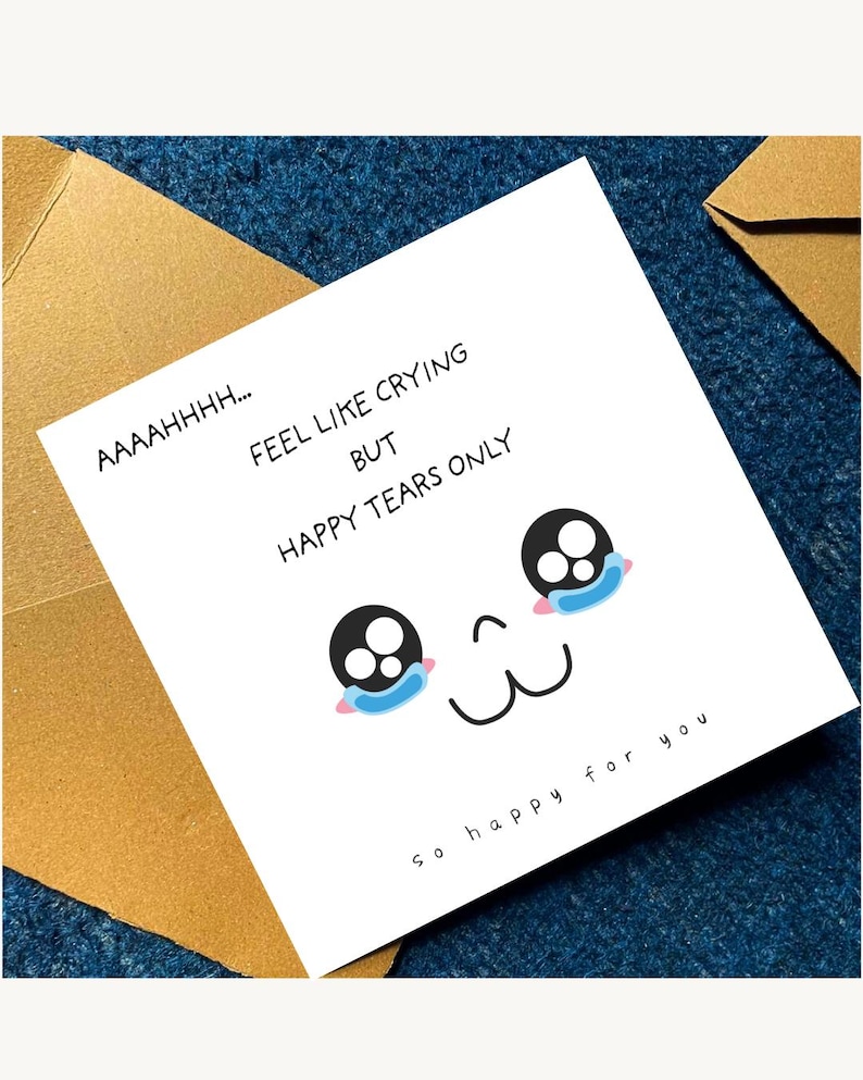 May include: A square white greeting card with black text that reads AAAAHHHH... FEEL LIKE CRYING BUT HAPPY TEARS ONLY and so happy for you. The card features a graphic of a face with large black eyes and blue tear-shaped accents below them.