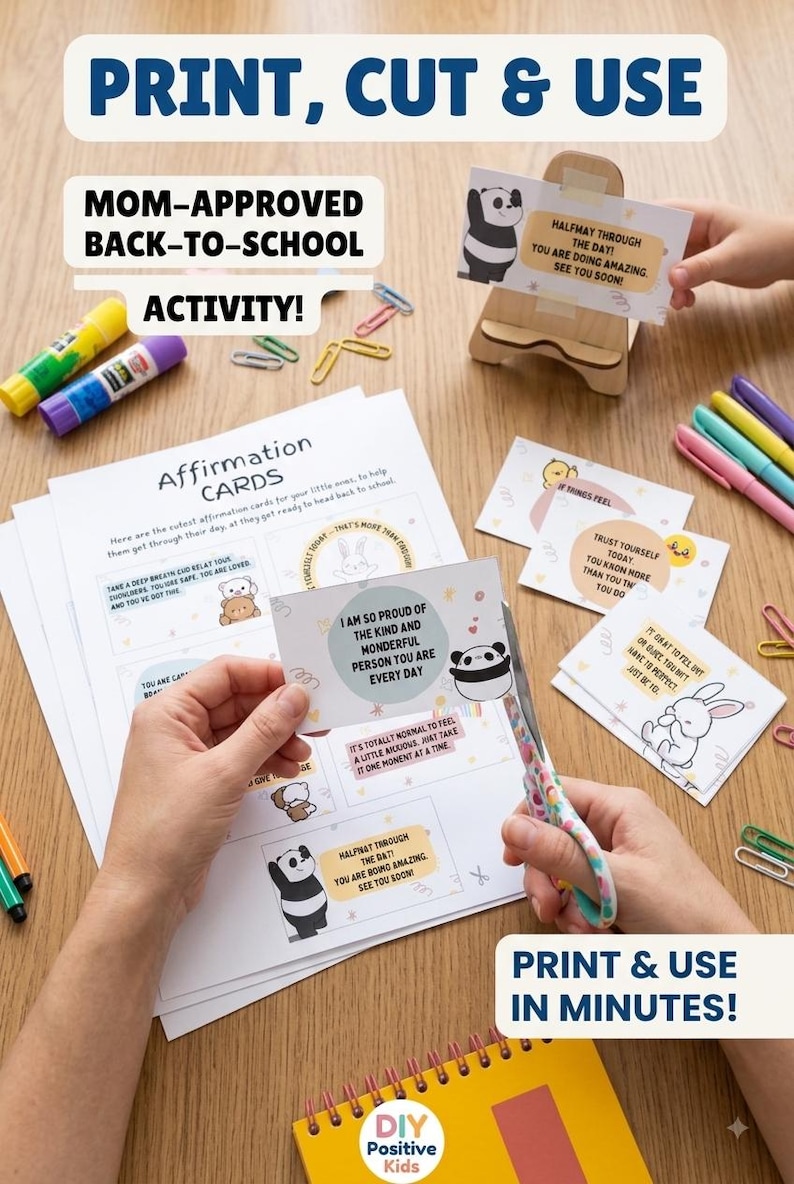 May include: A set of printable affirmation cards featuring cartoon characters and encouraging text. The cards are displayed on paper sheets, with some being cut out using patterned scissors. Includes glue sticks, colourful paper clips, and a wooden stand.