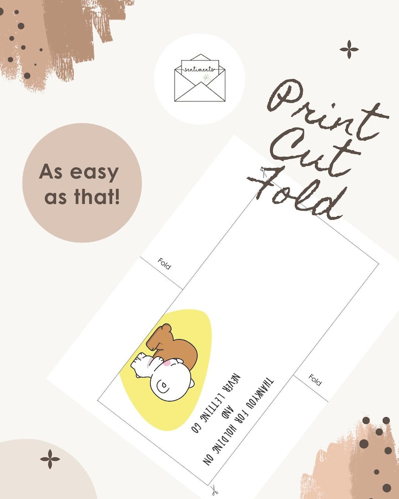 May include: A white card featuring a cartoon illustration of two characters hugging, set against a yellow oval. The card includes the text "Thank you for holding on and never letting go." The words "Print, Cut, Fold" are written in brown script.