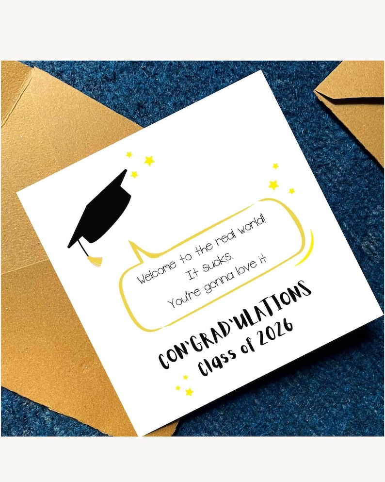 May include: A graduation card with a black mortarboard illustration and the text "Welcome to the real world! It sucks. You're gonna love it. CONGRATULATIONS Class of 2026." The card is white with yellow accents and is inside a brown envelope.