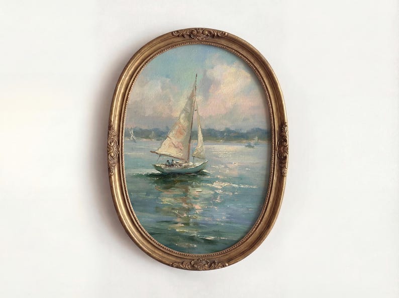 May include: An oval-shaped painting in a decorative gold frame depicting a sailboat on blue water under a cloudy sky. The artwork features visible brushstrokes and a maritime scene with a distant shoreline, captured in a classic, ornate frame.