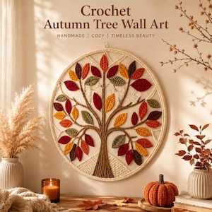 May include: Crochet Autumn Tree Wall Art. A circular wall hanging featuring a tree with colorful leaves in shades of red, orange, yellow, and green. The tree is made of brown yarn and is set against a cream-colored background. The text reads "HANDMADE | COZY | TIMELESS BEAUTY."