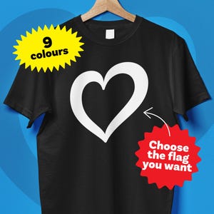 May include: Black t-shirt featuring a white heart graphic. The shirt has a round neck and short sleeves. A yellow starburst graphic says "9 colours", and a red starburst graphic says "Choose the flag you want".