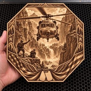 May include: An octagonal wooden plaque featuring a laser-engraved scene of a military helicopter hovering over a mountainous landscape with a waterfall. Two soldiers stand on a cliff edge, with American flag motifs, wings, and two dog tags at the base.