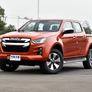 May include: An orange Isuzu pickup truck with black and silver wheels. The truck has a chrome grill and side steps. The front of the truck has the Isuzu logo and a license plate with Chinese characters.