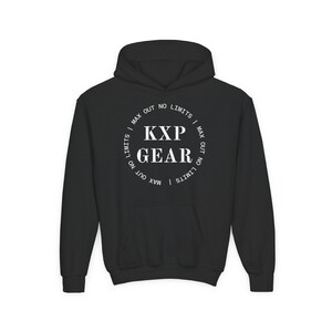 May include: Black hooded sweatshirt with a front pocket and drawstring. The white circular graphic on the chest reads "KXP GEAR" with "MAX OUT NO LIMITS" around the edge. A casual, comfortable garment.