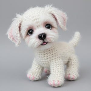 May include: A handmade white crochet dog with pink accents on the ears and paws. The dog has large, dark eyes and a small pink tongue sticking out. The dog is standing on a gray surface.