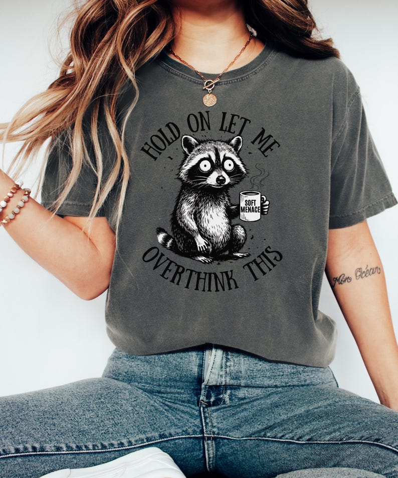 Raccoon shirt in Pepper — Hold On Let Me Overthink This graphic tee on model — Comfort Colors 1717 dark colorway — oversized funny shirt for women — raccoon meme tee — soft menace apparel