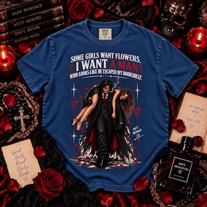 Blue Jean Comfort Colors 1717 dark romance reader shirt featuring distressed cream and blood red gothic artwork of a brooding fictional man carrying a woman with “Some Girls Want Flowers, I Want a Man Who Looks Like He Escaped My Bookshelf.” Spicy reader graphic tee for BookTok fans, book boyfriend lovers, morally gray men readers, fictional boyfriend enthusiasts, romance novel lovers, gothic book lovers, and dark romance readers by Soft Menace Co.