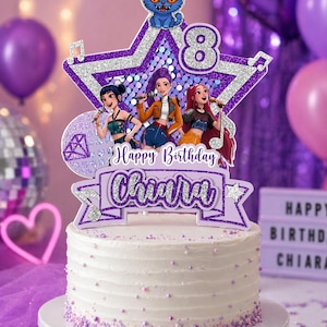 May include: A white frosted cake topped with a glittery purple and silver star-shaped cake topper featuring three cartoon singers, a blue cat, the number 8, and a banner with the text Happy Birthday Chiara in purple and silver glitter script.