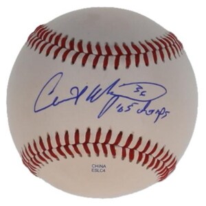 May include: A white baseball with red stitching featuring a blue ink autograph and the handwritten inscription '36 05 champs'. The ball has the text 'CHINA' and 'ESLC4' printed in small blue letters near the bottom edge of the leather surface.