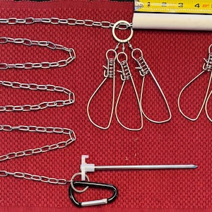 May include: A metal chain, wire loops, and a metal rod with a black carabiner clip are displayed on a red surface. A yellow tape measure shows the length of the object. The wire loops are in a teardrop shape.