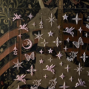 May include: A decorative panel featuring a unicorn, stars, butterflies, and other celestial elements. The design incorporates a tapestry-like background with a dark color palette and metallic accents. The panel has a vintage aesthetic.