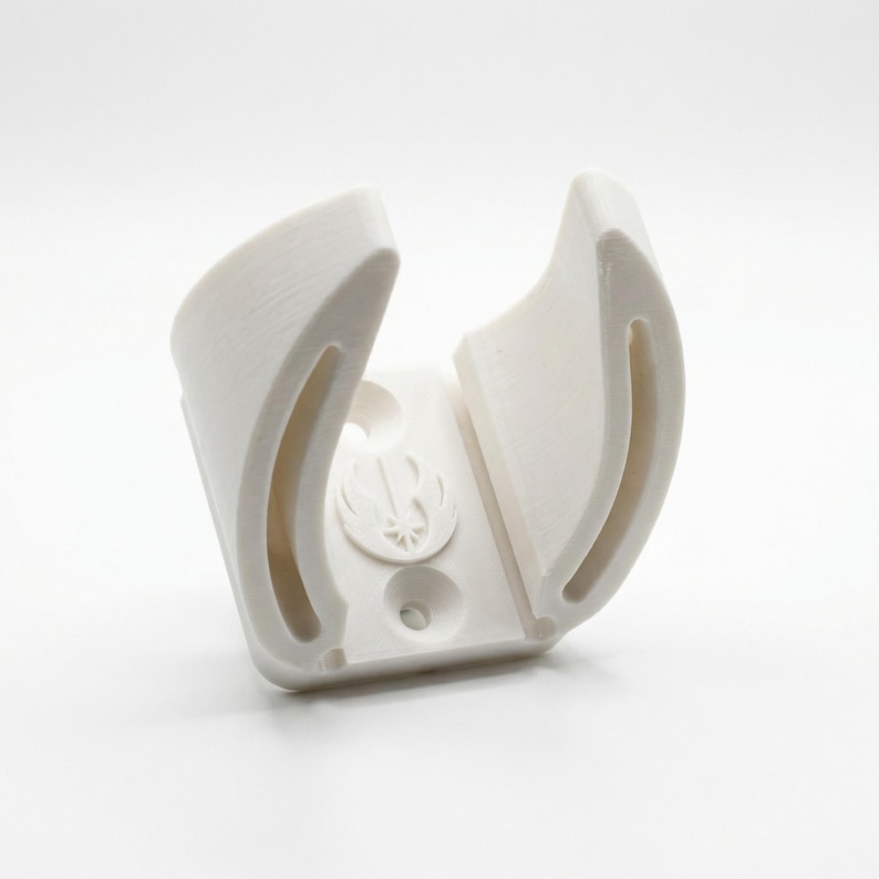 May include: A white 3D-printed holder with a curved design. The holder features a circular emblem and two curved slots. The object is designed to hold a specific item, likely a lightsaber or similar prop.