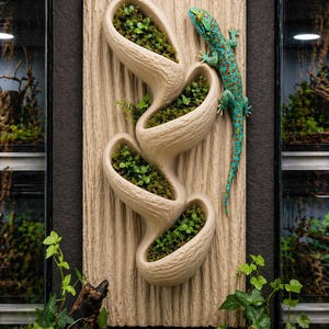 May include: A beige wall planter with four oval pockets filled with green plants. A turquoise and orange gecko is on the side. The planter has a textured, wood-like appearance. The image is framed by lush greenery.