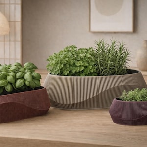 May include: A white ceramic mug with a black handle and the text "But First, Coffee" in a bold, black font. The mug is set against a blurred background, suggesting a cozy setting.