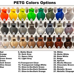 May include: A color chart displaying 27 PETG color options. The colors are arranged in rows and columns, with each color represented by a small, boat-shaped object. The colors include red, orange, yellow, green, blue, and various shades of gray, brown, and white. Text labels identify each color.