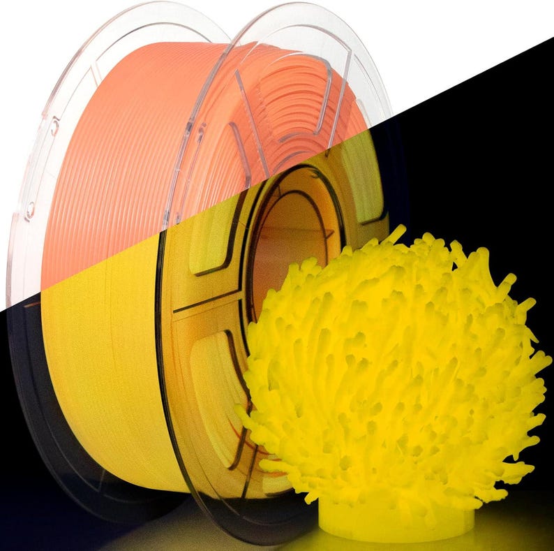 May include: A spool of orange 3D printing filament and a yellow, coral-like 3D printed object. The filament is wound on a clear plastic spool. The coral-like object is on a yellow base.