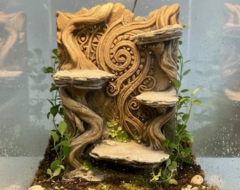 May include: A detailed, beige-colored terrarium background with a tree-like design. It features multiple stone-like platforms and intricate carvings. Green plants are interspersed throughout, creating a naturalistic environment. The background is designed to fit inside a glass enclosure.