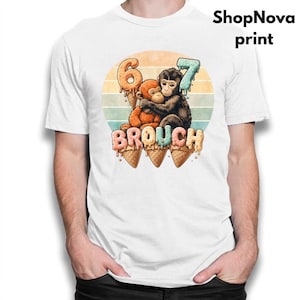 May include: White t-shirt featuring a colorful graphic of two hugging monkeys with the numbers 6 and 7 above them. The word "BROUCH" is written below the monkeys, and the text "ShopNova print" is in the upper right corner.