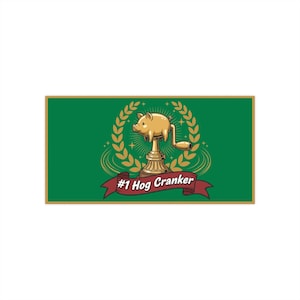 May include: A gold-colored pig cranker trophy on a green background. The trophy features a pig with a crank handle, set on a decorative base, surrounded by a laurel wreath. The banner reads "#1 Hog Cranker."