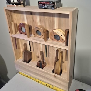 May include: A white ceramic mug with a black handle and the text "But First, Coffee" in a handwritten style. The mug is likely for hot beverages and has a glossy finish.