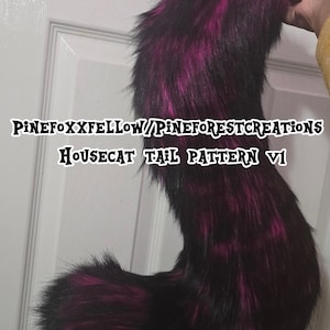 May include: A long, curved faux fur tail featuring a black and vibrant magenta striped pattern. The text PINEFOXXFELLOW/PINEFORESTCREATIONS HOUSECAT TAIL PATTERN V1 is overlaid across the center of the plush, textured accessory.