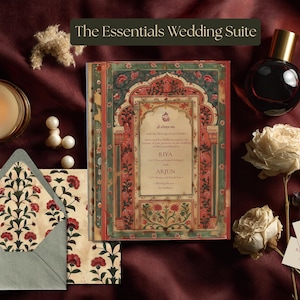 May include: The Essentials Wedding Suite invitation card features an ornate archway design with red floral motifs and green borders. It includes a matching envelope with a floral interior, two small rectangular cards, a candle, and a perfume bottle.
