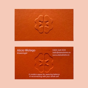 May include: Two orange business cards with a debossed brain-like logo. The bottom card includes the name, title, phone number, email, and website. The tagline reads: "A modern space for restoring balance & reconnecting with your whole self."
