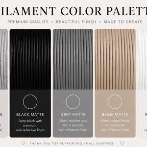 May include: A filament color palette chart displaying five coiled material options: white marble with grey specks, black matte, grey matte, beige matte, and white matte. Each section includes a color swatch and descriptive text for the finish.