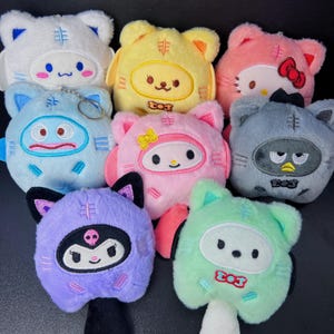 May include: A set of three ceramic mugs with a speckled, matte finish. The mugs are in shades of cream, light gray, and dark gray. Each mug has a simple, minimalist design, perfect for coffee or tea.