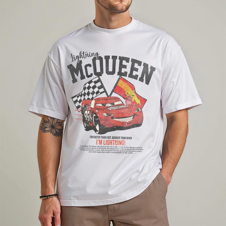 May include: White t-shirt featuring a graphic of Lightning McQueen from the Cars movie. The design includes the text "Lightning McQueen" above the car image, and "I'm faster than fast, quicker than quick, I'm Lightning!" below.