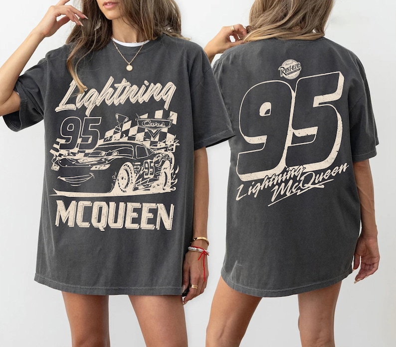 May include: A white ceramic mug with a black handle and the text "But First, Coffee" in a black, handwritten-style font. The mug is on a white surface.