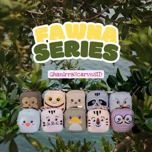 May include: A collection of small, square pouches with animal faces, including a monkey, owl, raccoon, and tiger. The pouches are in various colors and have a zipper closure. The text "FAUNA SERIES" is displayed above the pouches.