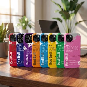 May include: A collection of colorful phone cases featuring the Red Bull logo and various edition names. Each case has a different color scheme, including red, blue, purple, orange, blue, yellow, green, and pink. The cases are designed to fit a smartphone.