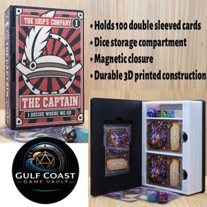 May include: A black and red 3D printed card storage box titled The Captain, featuring a hat graphic and the text I Decide Where We Go. The open box reveals a white interior with a dice compartment and slots for cards, alongside a Gulf Coast Game Vault logo.