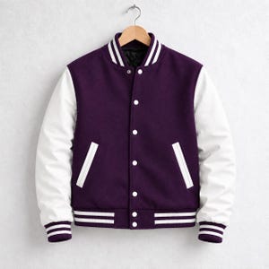 Op de afbeelding: Een varsity-jack met een donkerpaarse body van wolmix en contrasterende witte mouwen. Het kledingstuk is voorzien van een drukknoopsluiting aan de voorzijde, twee zijzakken met witte bies en geribbelde boorden en zoom met witte streepdetails.
