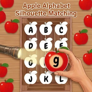 Könnte beinhalten: Ein pädagogisches Apple Alphabet Silhouette Matching Spiel mit einer Holzkiste und weißen apfelförmigen Ausschnitten mit den Buchstaben A bis L. Eine Hand hält einen roten Apfel mit dem Buchstaben g, während eine Taschenlampe das Brett beleuchtet.