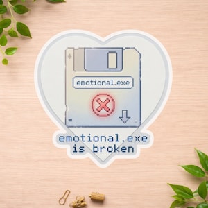 May include: A sticker in a heart shape featuring a pixelated floppy disk design. The text on the sticker reads "emotional.exe" and "emotional.exe is broken". The floppy disk has a red "X" symbol.