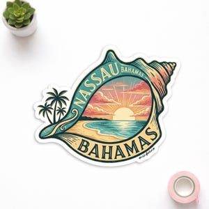 May include: A sticker featuring a seashell design with the words "Nassau Bahamas". The image inside the shell depicts a beach scene with palm trees, ocean, and a sunset. The sticker has a white border.