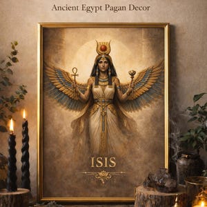 May include: A framed print featuring the Egyptian goddess Isis, with text above reading "Isis Egyptian Goddess Wall Art Printable." The artwork depicts Isis with outstretched wings, holding an ankh and a lotus flower. The word "ISIS" is at the bottom.