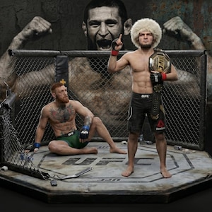 May include: A detailed diorama featuring two UFC fighters in a cage. One fighter stands with a championship belt, while another sits. The background includes a large, stylized image of a face and arms. The cage is set on a platform with the UFC logo.