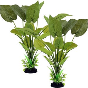 May include: Two artificial aquatic plants with large, green leaves and smaller, lighter green foliage at the base. The plants are mounted on small, black, rock-like bases, designed for aquarium use. The leaves have detailed veining.