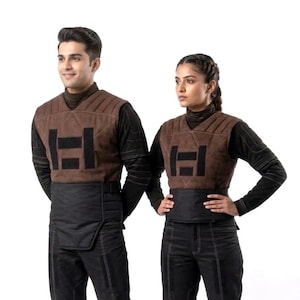 A premium galactic bounty hunter cosplay costume worn by a male model looking sideways, showcasing the screen-accurate ribbed double-sleeve detailing, dark brown flak vest, and black tailored undersuit over a solid white background.