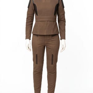 Brown Bo-Katan inspired tactical flight suit tunic with ribbed chest detailing and leather shoulder accents on a solid white background.