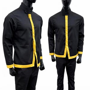 May include: A black long-sleeved jacket featuring a high collar and a vertical yellow stripe running down the center front opening. The jacket includes matching yellow trim along the sleeve cuffs and the bottom hem, worn with black trousers.