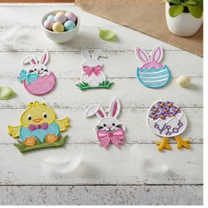 May include: Embroidered Easter-themed patches featuring bunnies, chicks, and decorated eggs. The patches are in various colors, including pink, blue, yellow, and green, with white accents. The designs include bows, grass, and floral patterns.