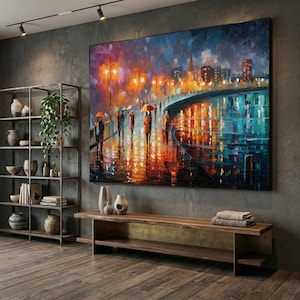 May include: Large, rectangular oil painting depicting a rainy cityscape at night. The artwork features figures with umbrellas walking along a bridge, with vibrant reflections in the wet pavement. The color palette includes blues, oranges, and yellows.