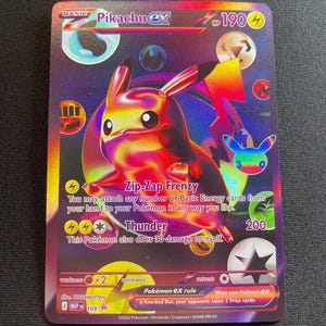May include: A holographic Pikachu ex trading card with a metallic rainbow finish. The card features the character Pikachu, the text Zip-Zap Frenzy and Thunder, 190 HP, and various elemental energy symbols. The bottom includes the Pokémon ex rule.