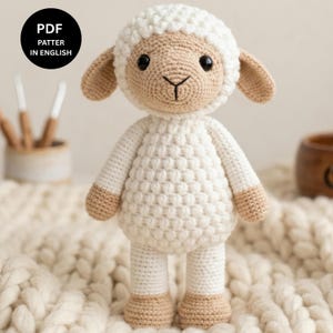 May include: A crocheted lamb doll, featuring a white body and head, with tan ears, feet, and hands. The lamb has black eyes and a stitched face. The image includes the text "PDF PATTERN IN ENGLISH" in a black circle.